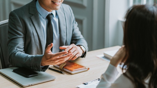 Asian male director is interviewing to recruit new employees