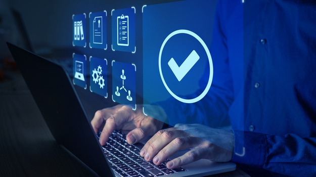 Quality management with QA (assurance), QC (control) and improvement. Standardisation and certification concept. Compliance to regulations and standards. Manager or auditor working on computer.